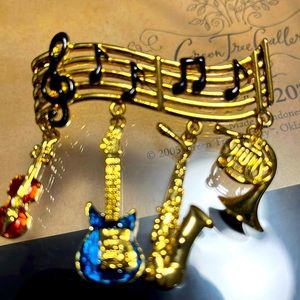 New and boxed musical note pin. Gold tone